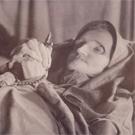 An elderly woman with a rosary